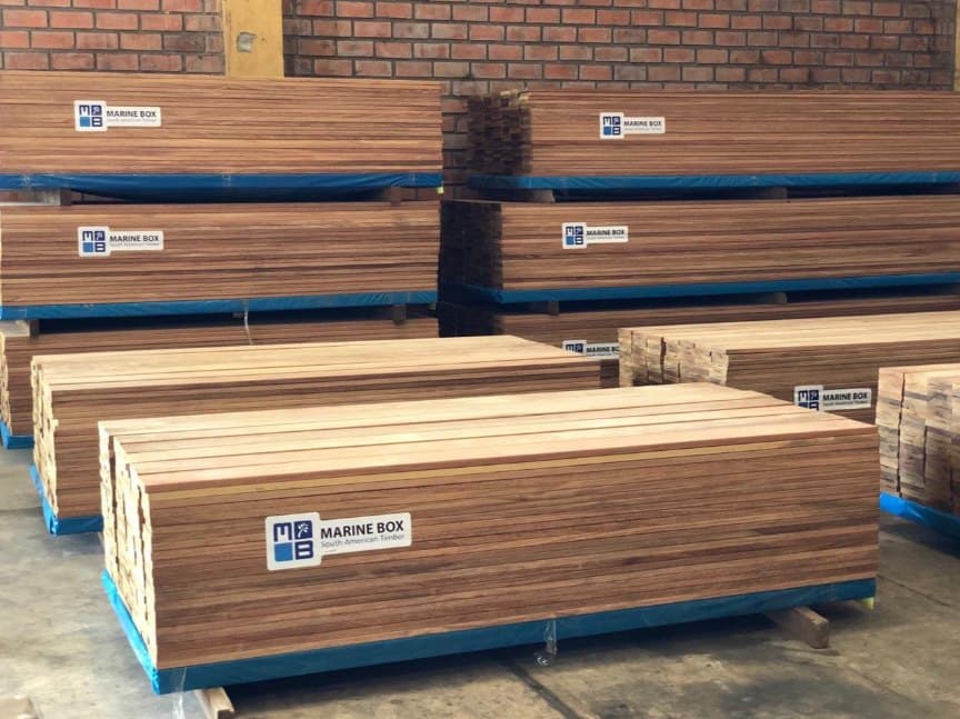 Stacked Marine Box hardwood bundles, each labelled and strapped, in the export warehouse